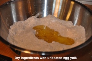 Dry ingredients with unbeaten egg yolk