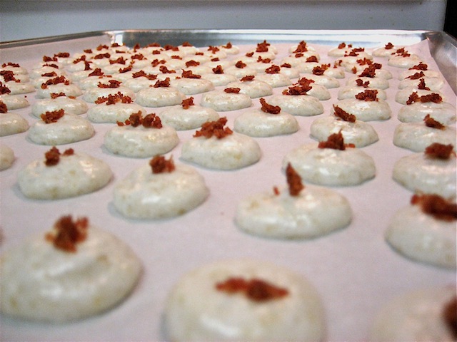 Piped macaron batter onto baking sheet