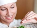 6929405-close-up-of-a-beautiful-female-chef-preparing-a-pizza-in-a-kitchen_thumb