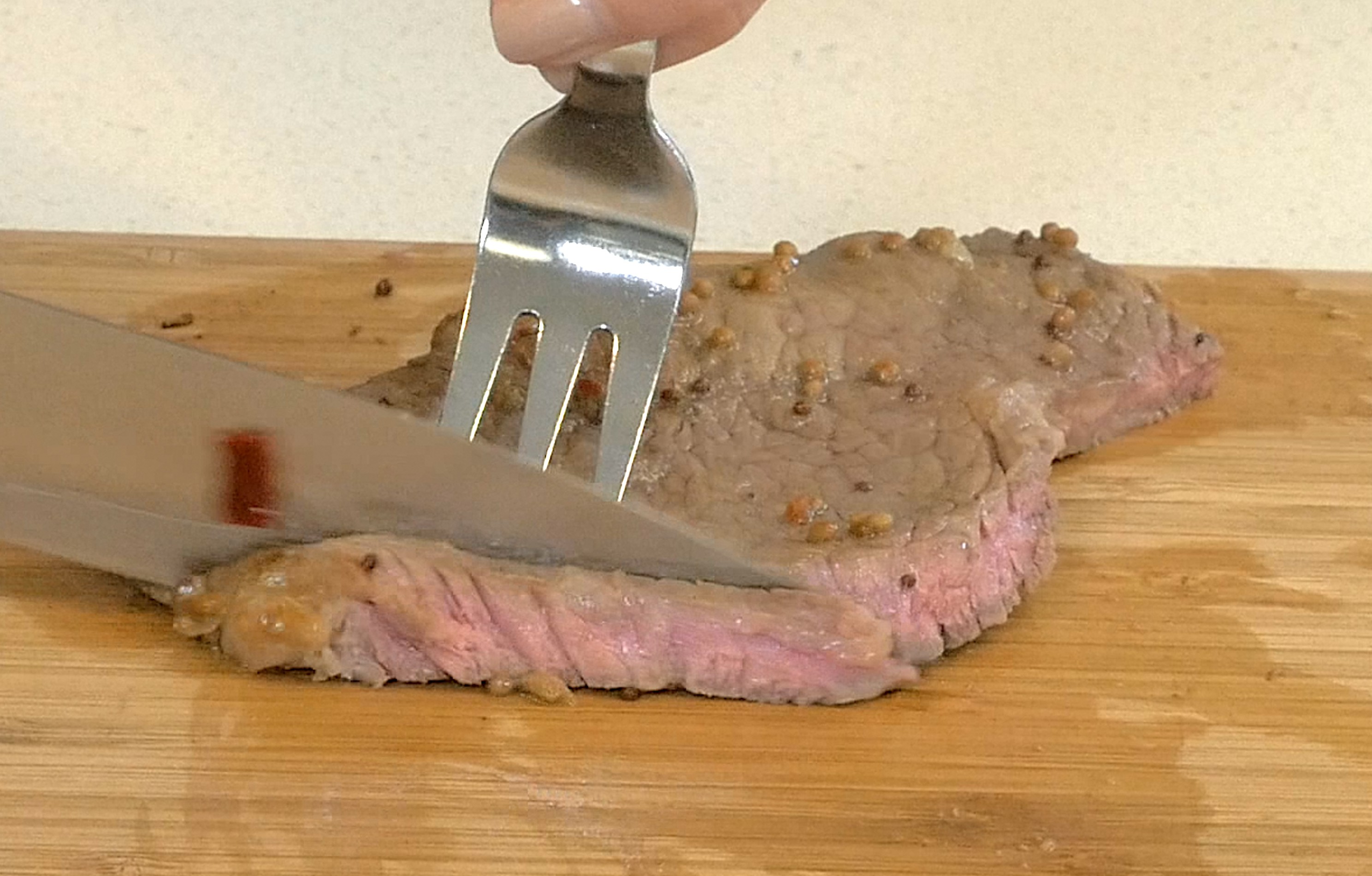 cutting steak with spice